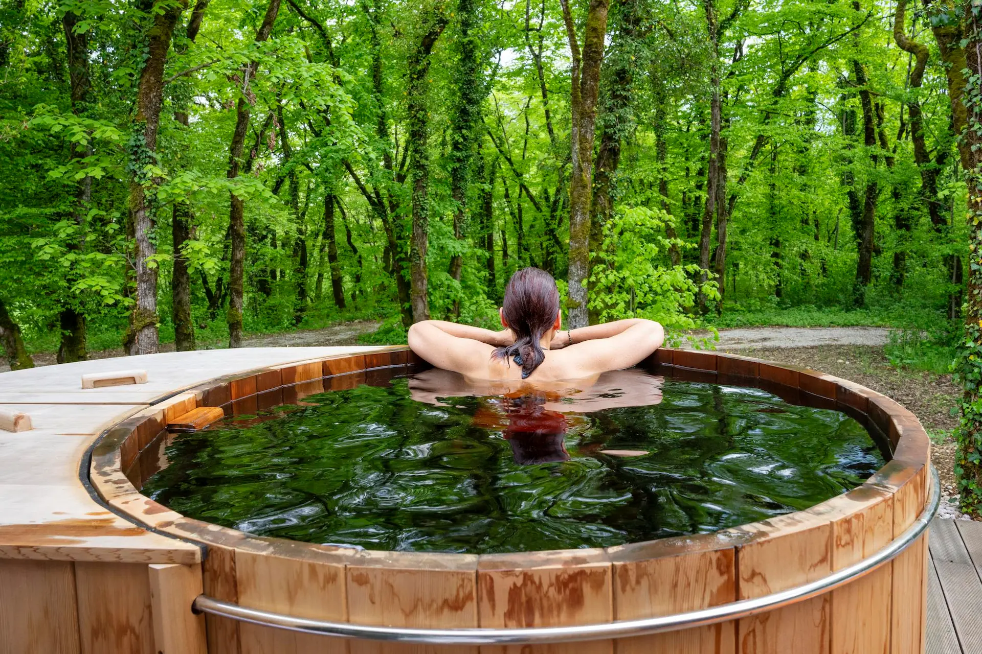 woman in hottub looking at the forrest